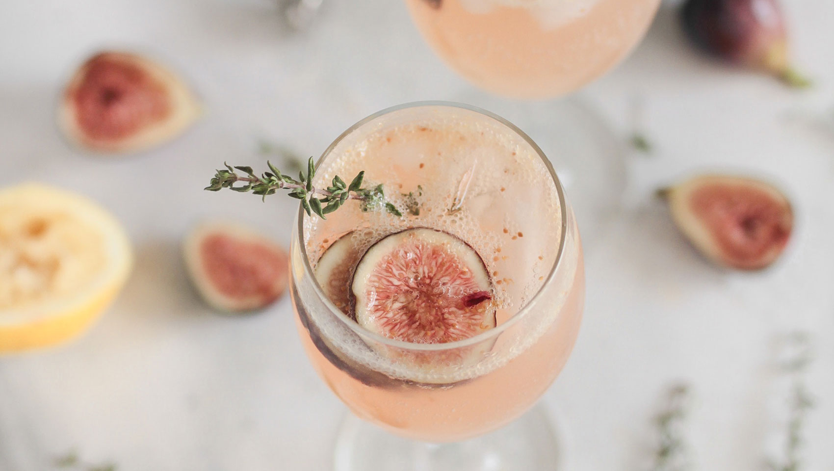 two cocktails with figs as garnish