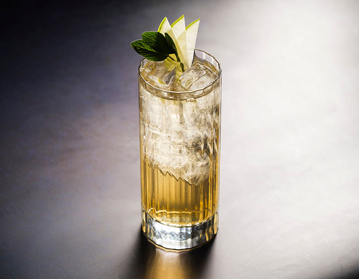 Cocktail with mint and pear garnish