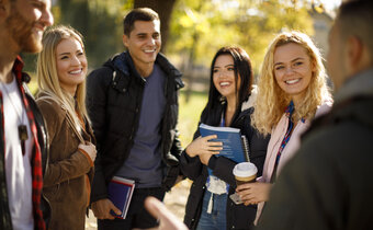 Students on a college tour listen to guide speaking